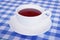 Porcelain white cup of black tea on the patchwork fabric background