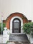 Porch with an arched iron door with a wrought pattern