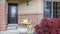 Porch with bench of a home with glass paned door and concrete and brick wall