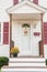 The porch of a small cozy wooden house and with yellow chrysanthemums on the threshold.