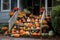 porch steps lined with assorted colorful pumpkins