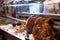 Porchetta at desk. Slicing handmade porchetta at the food counter of a market.