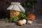 Porcini mushroom commonly known as Boletus Edulis and glass jar with canned mushrooms on vintage wooden background