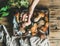 Porcini mushrooms in wooden tray and woman`s hand holding mushroom