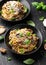 Porcini and woodland mushrooms pasta with pecorino cheese, basil in black bowl