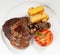 Pork chop steak with fried potatoes, mushrooms and tomato