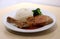 Pork Chop Steak white rice and green broccoli in the dish on the wooden table.