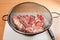 Pork in a colander on a table