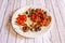 Pork escalopes recipe with dehydrated tomatoes, piquillo peppers, black olives and oregano