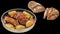 Pork Ham Baked with Potatoes in Casserole and Whole Grain Domestic Rustic Brown Bread Cut Loaf Isolated On Black Background