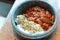 Pork Jeyuk with rice and sesame in heated stone bowl