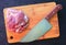 Pork meat and knife on wooden board. Cutting meat by chef knife.