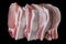 Pork meat steaks close-up on a black background, isolate, close-up, top view