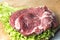 Pork-neck meat steaks on lettuce on the background of radishes, tomato, red chili peppers, yellow chili peppers, green paprika,