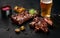 Pork ribs in barbecue sauce and a glass of beer on a black slate dish. A great snack to beer on a dark stone background