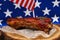 Pork spare ribs in bbq sauce over American flag