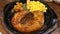 Pork steak in a hot frying pan, ready to eat with corn potato carrot and crispy sticky rice