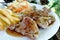 Pork steak, vegetable salad, potato chips.