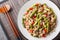 Pork Stir Fry with asparagus, garlic, chili and ginger closeup on the plate. Horizontal top view