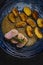 pork tenderloin with baked potatoes and French coarse mustard sauce