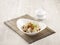 Pork Wanton in Chilli Vinaigrette with chopsticks served in a dish isolated on mat side view on grey background