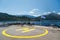 Poros, Cephalonia island, Greece - July, 17 2019: Yellow sign of helipad for helicopters at the ship and passengers relaxing at