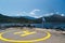 Poros, Cephalonia island, Greece - July, 17 2019: Yellow sign of helipad for helicopters at ship and passengers relaxing