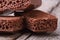 Porous brown chocolate on old wooden table closeup.