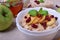 Porridge with caramelized apples and dried cranberries topped with mint
