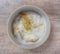 Porridge for children, soft food in ceramic cups  Wooden table background