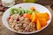 Porridge with fresh fruit and cranberries. Healthy breakfast.