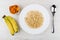 Porridge from oat flakes with milk, bananas, dried apricots