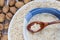 Porridge with a Wooden Spoon with Walnut on a Background