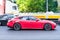 Porsche Panamera GTS at the City streets in motion. Red Porsche panamera is driving in traffic, side view