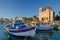 Port of Aegina town with yachts and fishermen boats docked in Aegina island, Saronic gulf, Greece, at sunrise