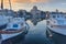 Port of Aegina town with yachts and fishermen boats docked in Aegina island, Saronic gulf, Greece, at sunrise