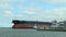 PORT ARANSAS, TX - 14 FEB 2020: The bow of the SARA, a crude oil tanker ship, and a tug boat, as they sail past the ferry boats at