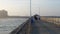 PORT ARANSAS, TX - 17 FEB 2020: People on an ocean fishing pier at the Gulf of Mexico on a hazy evening