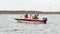 PORT ARANSAS, TX - 24 FEB 2020: Fishing boat with outboard motor and 3 men