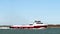 PORT ARANSAS, TX - 6 FEB 2020 - The CRYSTAL CLEAR, a red and white commercial boat sails by San Jose Island on the ship channel