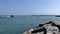 Port Aransas, TX - 6 MAR 2016: Fisherman on rocks at marina entrance.