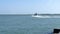 Port Aransas, TX - 6 MAR 2016: Jetty boat with tourists and fishermen leaves marina entrance.