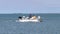 PORT ARANSAS, TX - 7 FEB 2020: Two men in a fishing boat, with rods and a net, sail past a green buoy as they return to the marina