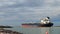 PORT ARANSAS, TX - 9 FEB 2023: OIL Tanker Ship sails by rock jetty