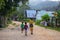 Port Barton, Philippines - 23 Nov 2018: Woman and children on dusty road. Filippino family on rustic village street