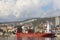Port city, Rijeka, Croatia, coast in the city, buildings on the shore of the port, harbor crane, big white clouds in the blue sky,