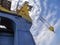 Port crane against the blue sky with clouds