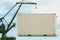 Port crane lifts White container. concept of worldwide delivery by marine transport or goods distribution to world, copy space