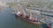 Port crane loads cargo into a dry cargo ship. Dry cargo ship at the port