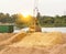 The port crane makes loading of wood chips into the freight wagons of the train, close-up, ladle